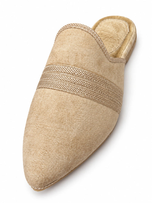 Beige pointed-toe babouche with a broad layered braided band and matching edging, shown on white.