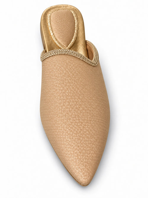 Beige babouche with a subtle woven texture and pale gold-tone braided edging on a white background.