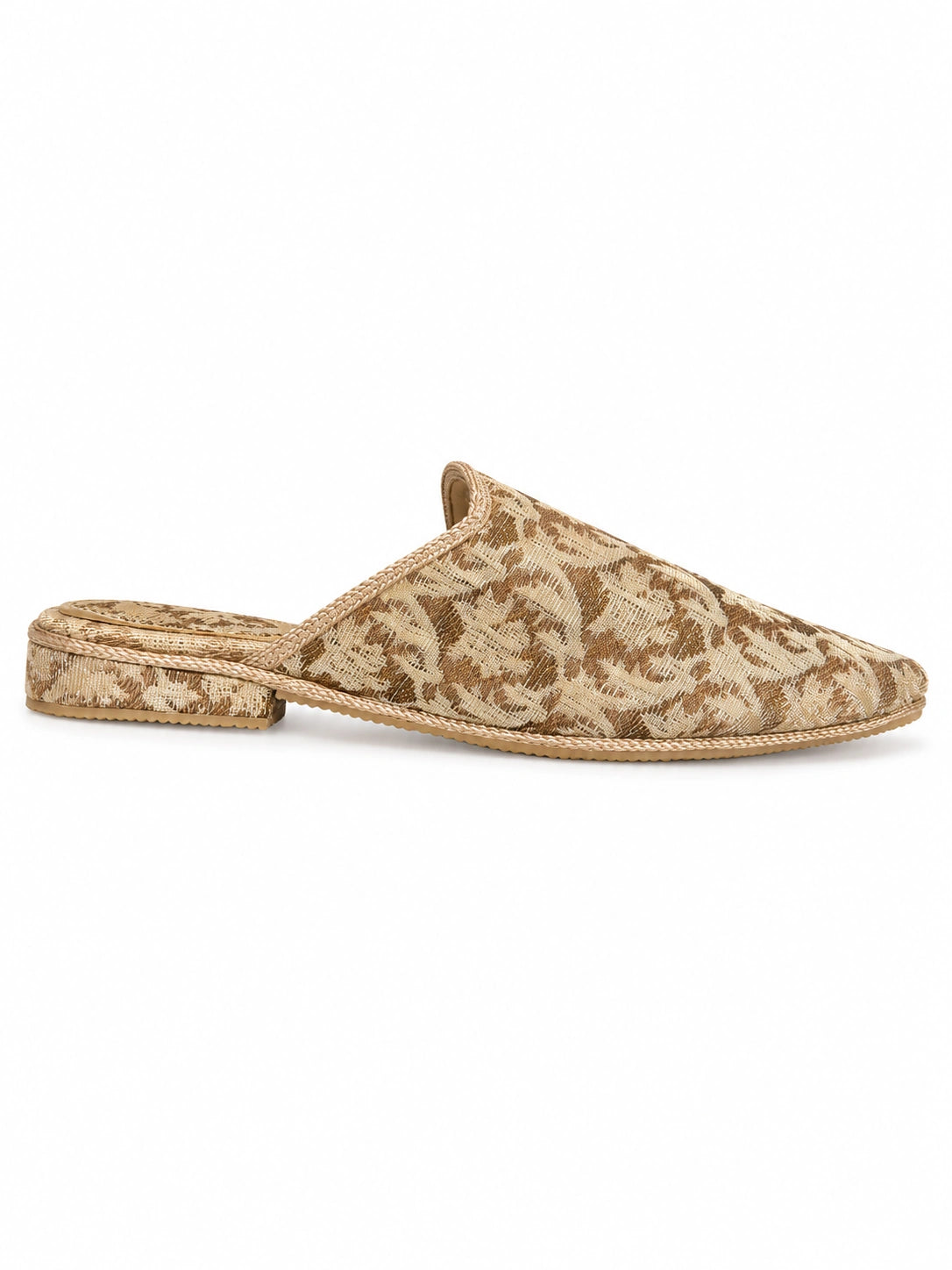 Side view of a beige and light brown ornamental-pattern babouche with braided trim and a low covered heel on white.