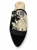 Black and cream abstract-pattern babouche with black braided front bands and a plain black pointed toe, shown on white.