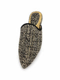 Black and cream textured pointed-toe babouche with black piping on a white background.
