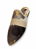 Brown, grey and gold patterned pointed-toe babouche with a beige braided band on a white background.