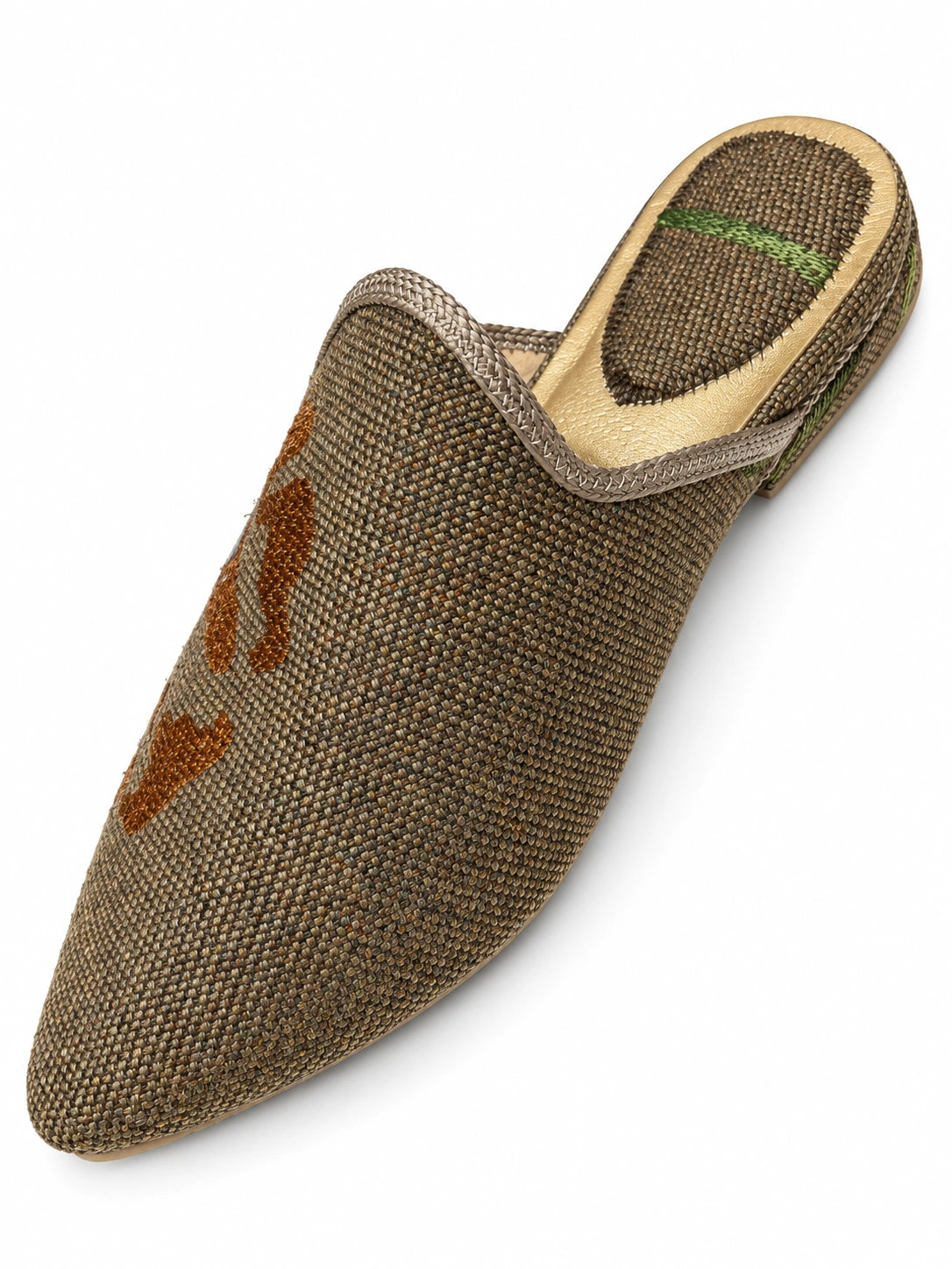 Brown and taupe woven babouche with rust-brown pattern details, braided edging and a pointed toe, shown on white.