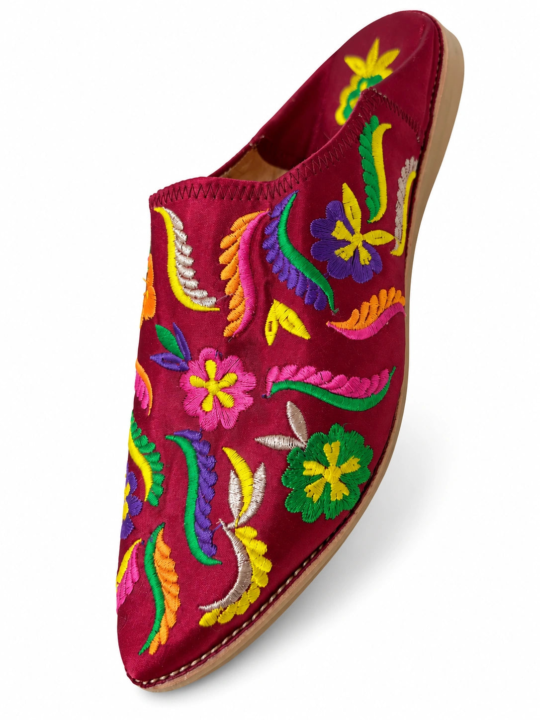 Burgundy babouche with multicolour floral embroidery and matching stitched edging on a white background.