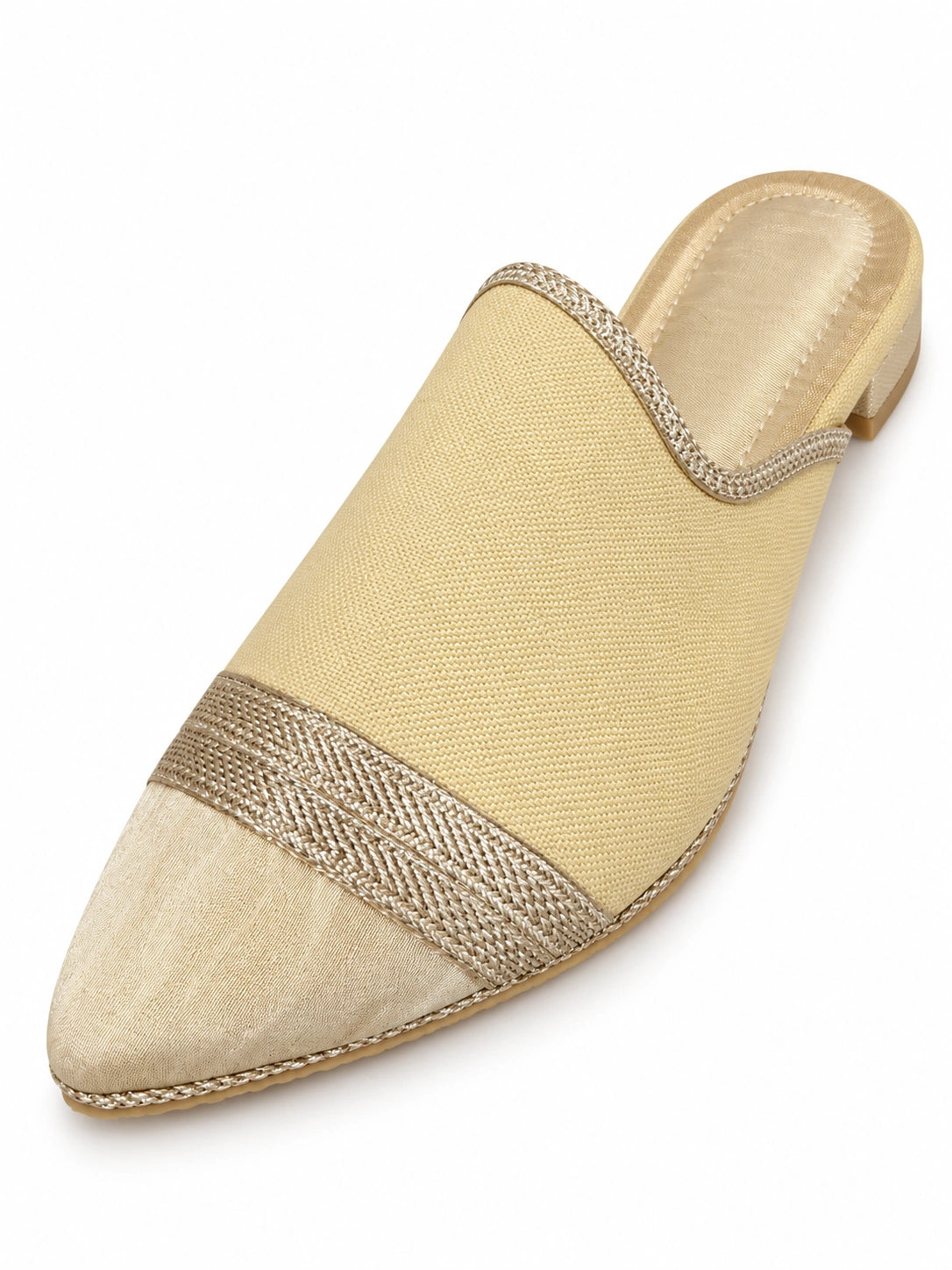Cream woven babouche with a pale gold-tone pointed toe, metallic braided band and open back on white.