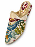 Cream babouche with multicolour botanical embroidery, gold sequin accents and braided edging on a white background.