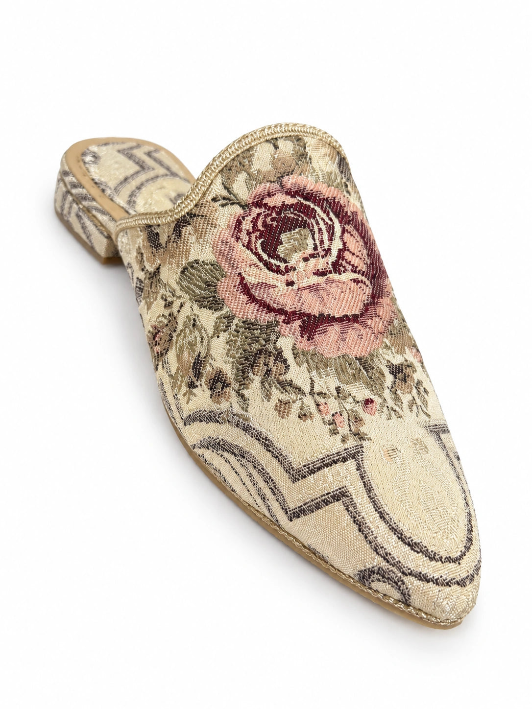 Cream babouche with a pink rose motif, olive leaves and a low covered heel on a white background.
