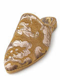 Gold and ivory babouche with large scrolling floral motifs, metallic braided edging and a patterned heel on white.
