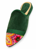 Forest green babouche with a colourful floral-patterned toe, green braided band and gold-tone heel rim on white.