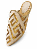 Ivory babouche with gold geometric sequin motifs and braided edging on a white background.