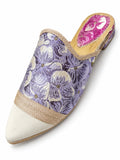 Lavender floral babouche with champagne braided trim, an ivory pointed toe and a pink patterned heel inset, shown on white.