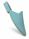 Light blue pointed-toe babouche with a fine woven texture and matching blue braided trim, shown at an angle on white.