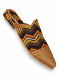 Babouche with orange, yellow, cream and brown chevrons, a bronze-tone braided toe cap and open back on white.