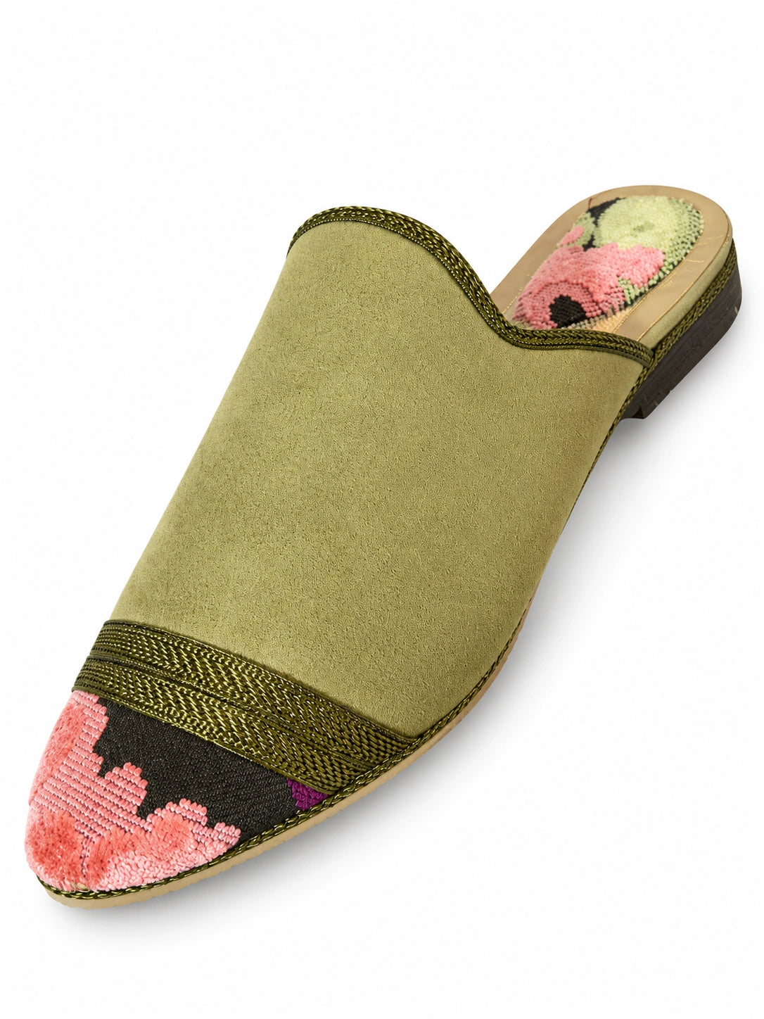 Olive green babouche with a tonal braided band and pink floral toe on a dark ground, shown on white.