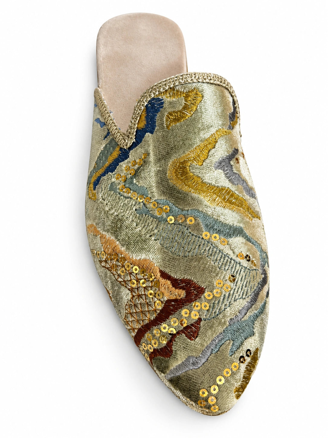 Pale blue-green ornamental babouche with gold, dark blue and rust motifs, gold sequins and metallic braided trim on a white background.