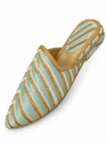Pale mint green babouche with diagonal ivory and metallic gold stripes, gold braid and a striped heel on white.