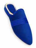 Royal blue textured babouche with a tonal braided band and gold-tone heel edging on a white background.
