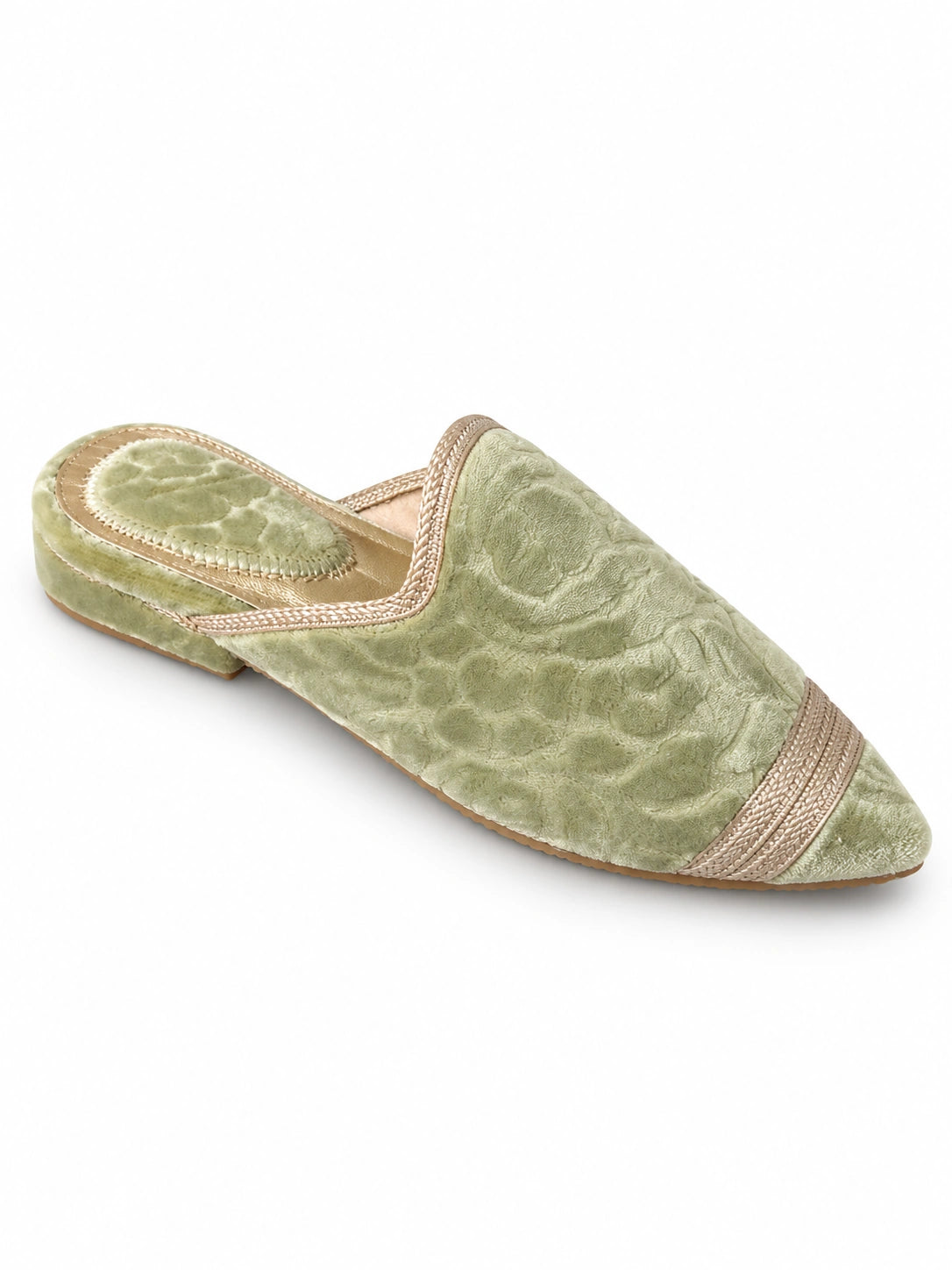 Sage-green babouches with a tonal floral texture and a pale champagne braided band near the pointed toe, on a white background.