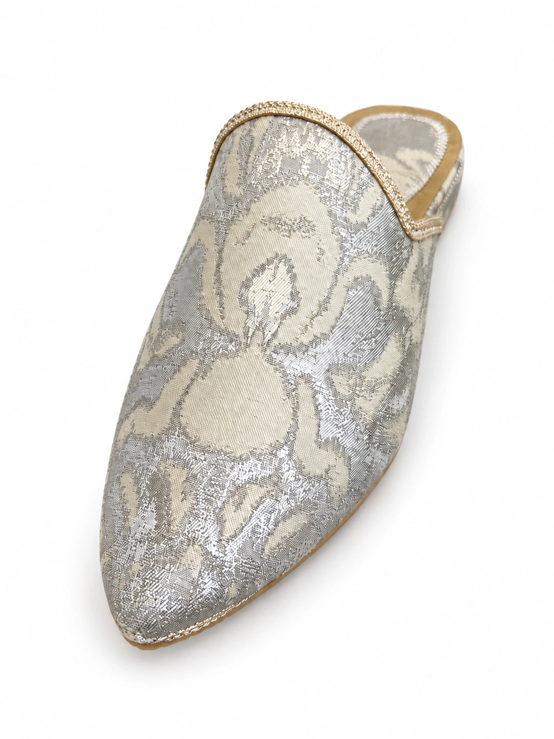 Silver and ivory floral pointed-toe babouche with gold-tone edging on a white background.