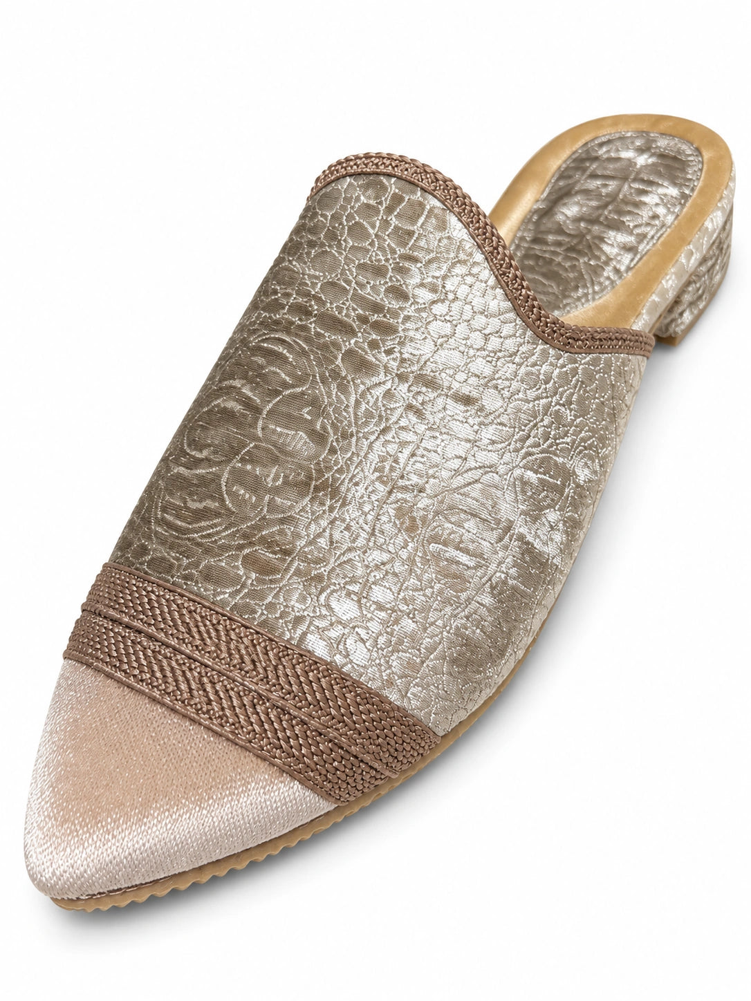 Silver patterned babouche with a pale beige pointed toe, taupe braided band and open back on white.