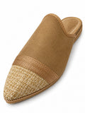 Tan babouche with a cream and gold-tone woven pointed toe, bronze-tone braided band and open back on white.