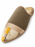 Taupe babouche with a cream, yellow and grey patterned toe and champagne braided trim on a white background.