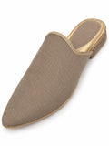 Plain taupe woven babouche with a pointed toe, narrow braided opening trim and open back on white.
