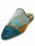 Babouche with pale aqua floral texture on an ochre ground, a plain teal toe and wide teal braided band on white.